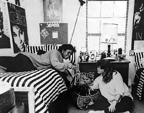 1980s photo of two women students sitting in their shared dorm room talking.