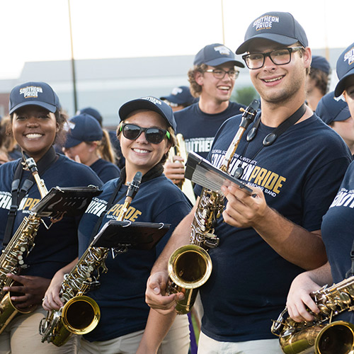 three saxophone players in the marching band 