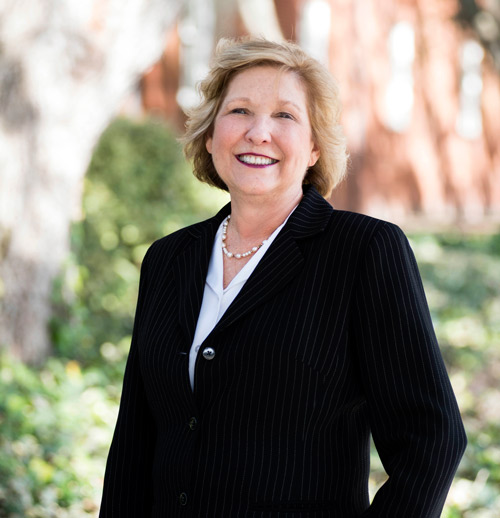Helen Taggart standing outside in a suit