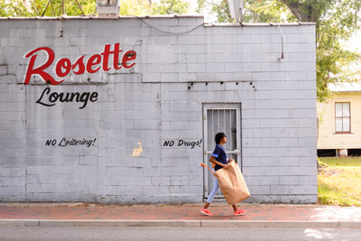 student walking past Rosette Lounge