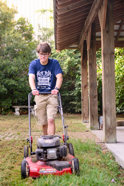 student mowing a lawn