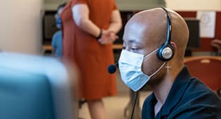 Chris Hill, a Master of Public Health student from Valdosta, Georgia, makes contact tracing calls at the CARES Center on the Statesboro Campus.