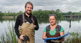Asli Aslan (R) and Luke Roberson (L) test the waters of the Ogeechee River at Kings Ferry beach.