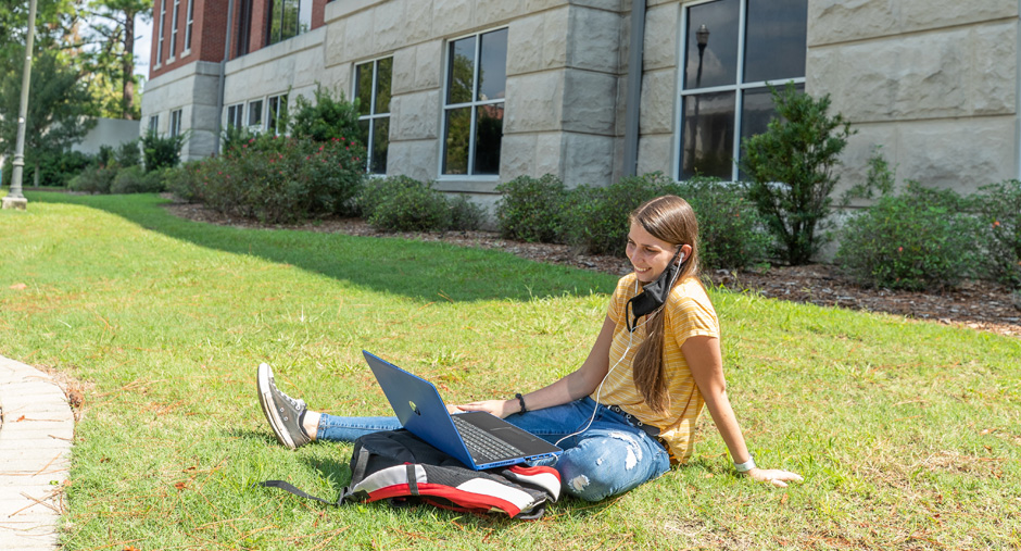 Student working outside the library