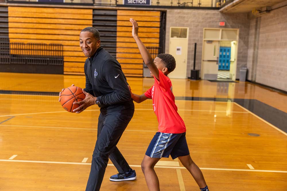 Sharman White (left) and his son (right) practice man-on-man defense.