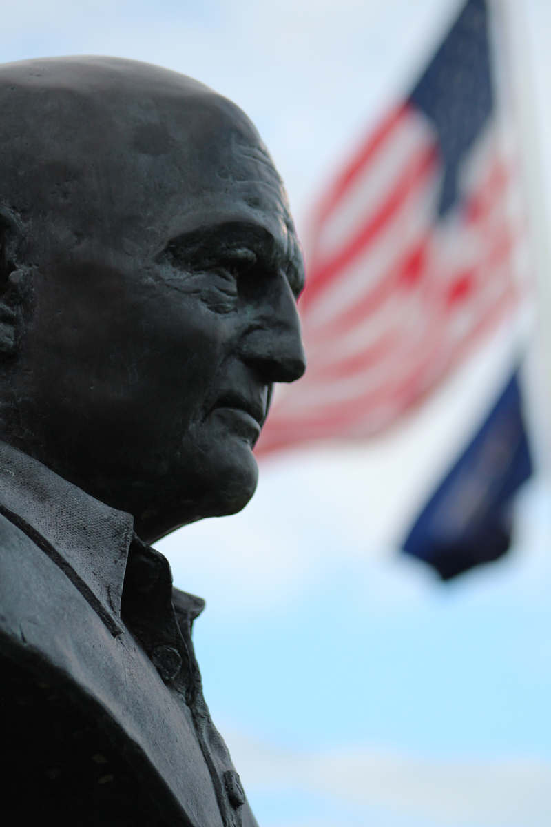 Erk Russell memorial statue with flags in the background.